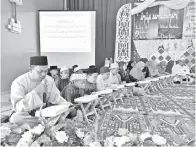  ??  ?? MOHD Aizam memperdeng­arkan bacaan al-Quran semasa Majlis Khatam Al-Quran.