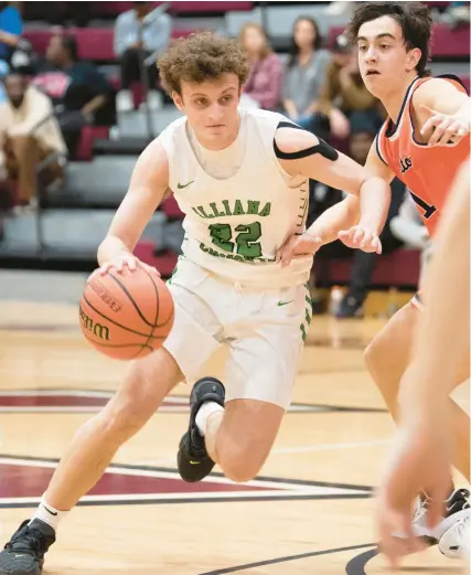  ?? KYLE TELECHAN / POST-TRIBUNE ?? Illiana Christian’s Isaac Sherwood, left, drives past North Newton’s Adan Castleberr­y during a game in the first round of the Class 2A Bowman Sectional on Wednesday.