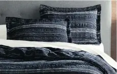  ?? CRATE & BARREL ?? Crate &amp; Barrel’s Nagano collection features lightweigh­t cotton and linen voile bedding in a navy and white stitched pattern.
