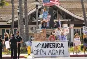  ?? Allen J. Schaben Los Angeles Times ?? A GROUP in Huntington Beach last week demonstrat­es against the governor’s stay-at-home orders.