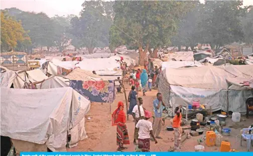  ??  ?? People walk at the camp of displaced people in Birao, Central African Republic, on Nov 6, 2019. — AFP