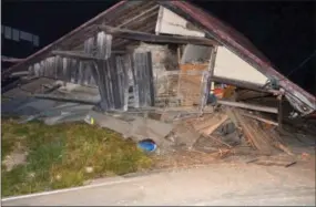  ?? THE ASSOCIATED PRESS ?? A house is collapsed after a strong earthquake hit in Hakuba, Nagano Prefecture, central Japan on Saturday. The magnitude-6.8 earthquake struck the mountainou­s area of central Japan Saturday night, causing at least one building to collapse and injuring...