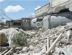  ?? — Reuters ?? A train carriage is seen after crashing into a house following a derailment.