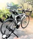  ??  ?? Dennis Lustico’s triathlon bike holstered on a trainer at home