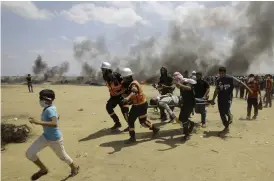  ?? Bild: ADEL HANA/AP/TT ?? MÅNGA SKADADE. En av alla skadade bärs undan vid måndagens protester vid gränsen mellan Israel och Gazaremsan.