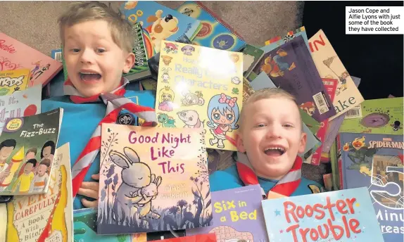  ??  ?? Jason Cope and Alfie Lyons with just some of the book they have collected