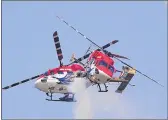  ??  ?? IAF’s helicopter aerobatic team 'Sarang' performs during the second day of Aero India 2021 at Yelahanka air base in Bengaluru on Thursday.