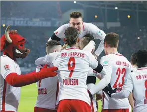  ?? AGENCE FRANCE-PRESSE ?? RB Leipzig players and the club’s mascot celebrate scoring during their 2-1 Bundesliga victory against Schalke 04 at Red Bull Arena on Saturday.