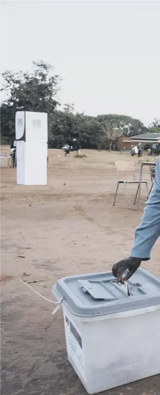  ??  ?? 0 A woman casts her vote at the Malembo polling station in Lilongwe on