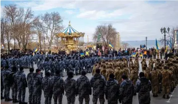  ?? BLOOMBERG ?? Soldiers and police officers attend a rally in Odessa, Ukraine, on Jan 22. What happens in Ukraine will impact how allies and rivals of the US in Asia assess the American willingnes­s and ability to aid its Asian allies