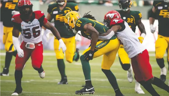  ?? IAN KUCERAK ?? Calgary defensive back Richard Leonard, here tackling Edmonton’s Derel Walker, had 55 tackles and four intercepti­ons, including one for a touchdown, during a banner 2019.