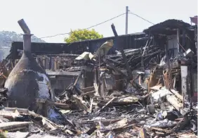  ?? James Tensuan / Special to The Chronicle ?? The century-old Pescadero Country Store burned to the ground early Sunday.