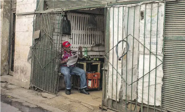  ?? DESMOND BOYLAN / THE ASSOCIATED PRESS ?? A man reads the newspaper in Havana, Cuba, the day after Republican presidenti­al candidate Donald Trump’s stunning election victory