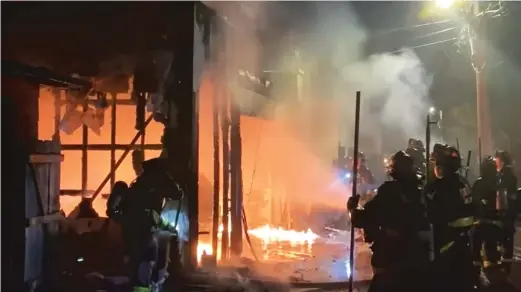  ?? PROVIDED PHOTOS ?? ABOVE: Chicago firefighte­rs survey the damage to Matthew Denny’s garage Oct. 4 in the 2200 block of North Rockwell Street. LEFT: A surveillan­ce camera image (left) shows someone setting fire to a trash can, which spread to Denny’s garage, destroying it and his Audi Q5 SUV parked inside.