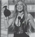  ?? ?? Jennifer Lopez accepts the award for best song for “On My Way (Marry Me)” at the MTV Movie & TV Awards on Sunday.