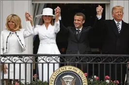  ?? ALEX WONG / GETTY IMAGES ?? U.S. President Donald Trump (right) and first lady Melania Trump (second left) with French President Emmanuel Macron and his wife Brigitte Macron.