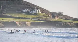  ?? ?? TOP TO BOTTOM
Members of Wave Wahines, a women- and girls-only surf club, during a lesson off Croyde Beach.