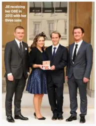  ??  ?? Jill receiving her OBE in 2013 with her three sons