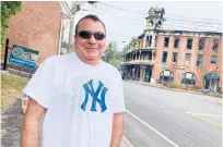  ?? DON STACOM/HARTFORD COURANT ?? Don Petruzzi, who played piano at Chatterly’s before it closed in 2017, went to New Hartford’s center Tuesday to see the New Hartford House after a devastatin­g fire.