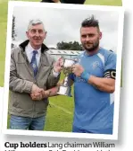  ??  ?? Cup holders Lang chairman William Miller presents Bob Davidson with the Jim Scoular Memorial Cup, which Lang and Kilby play for each year