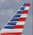  ?? ALAN DIAZ — THE ASSOCIATED PRESS ?? This Friday photo shows the tail of an American Airlines passenger jet at Miami Internatio­nal Airport in Miami. On Friday, American Airlines Group Inc. reported it had earned $950 million in the second quarter, beating Wall Street expectatio­ns.