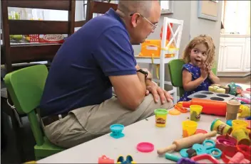  ?? Katharine Lotze/The Signal ?? Kyle Winning, left, plays with his 2-year-old daughter Jasmine Winning, who was born with two rare conditions, in their Valencia home on Wednesday.