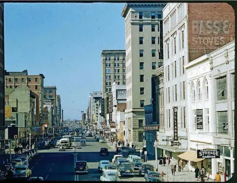  ?? [PHOTO PROVIDED BY OKLAHOMA HISTORICAL SOCIETY] ?? This undated Kodachrome slide was among a handful of color slides of downtown Oklahoma City recently scanned and added to the online collection­s of the Oklahoma Historical Society. This photo is looking west along Main Street from what is now E.K. Gaylord Boulevard. The fourth building on the right is the one building still standing, home to BancFirst.