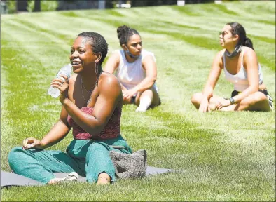  ?? Matthew Brown / Hearst Connecticu­t Media ?? Participan­ts stay hydrated during the Justice for Brunch Mental Wellness in the Black Community event Saturday. Participan­ts took part in guided meditation and breathwork, listened to the spoken word, speakers and music, got physical with a superhuman class and yoga and painted in the fresh air and shade of trees in the park.