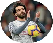  ??  ?? Liverpool star Mohamed Salah keeps the match ball after his hat-trick at Bournemout­h.