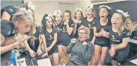  ?? Photo / Warren Buckland ?? Christine Crowe, the director of Bay City Cheerleade­rs, and the Comets senior competitio­n team find out they will represent New Zealand in Hawaii.