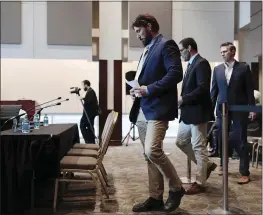  ?? JOSHUA A. BICKEL — THE COLUMBUS DISPATCH VIA AP ?? Dan Ritchie walks with Mike Schyck and Brian Garrett as the three prepare to speak before a meeting of the Ohio State University Board of Trustees on Thursday,