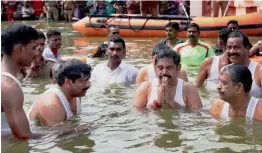  ?? — PTI ?? Tamil Nadu CM K. Palaniswam­i takes a holy dip in the Cauvery river during the Cauvery Pushkarani fest on Wednesday.