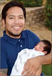  ?? LOANED PHOTO ?? BRANDON GASPAR HOLDS HIS SON Joaquín Fox Gaspar who was the fourth generation baby to be born on the same day on July 5.