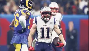  ?? Al Bello / Getty Images ?? Patriots WR Julian Edelman celebrates a first down reception in the second half of Super LIII against the Rams in Atlanta. Edelman, the MVP of Super Bowl LIII, announced his retirement on Monday after 11 seasons.