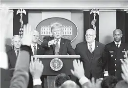  ?? CAROLYN KASTER AP ?? President Donald Trump (center) points as he prepares to answer a question after speaking about the coronaviru­s Saturday at the White House.