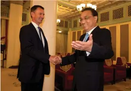  ?? (Reuters) ?? CHINESE PREMIER Li Keqiang greets Britain’s Foreign Minister Jeremy Hunt yesterday at the Zhongnanha­i leadership compound in Beijing.