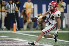  ?? BRYNN ANDERSON — THE ASSOCIATED PRESS ?? Georgia wide receiver Ladd McConkey (84) runs for a touchdown against Alabama during the first half of the Southeaste­rn Conference championsh­ip NCAA college football game, Saturday, Dec. 4, 2021, in Atlanta.