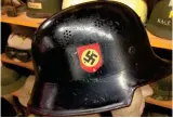  ?? ?? The right-hand side of a M1934 Polizai lightweigh­t helmet with a nicely preserved National Socialist decal (germanhelm­etvault.com)