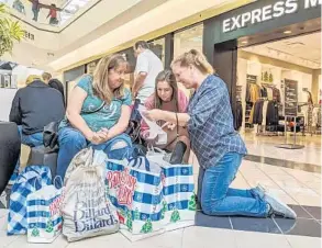  ?? SARAH ESPEDIDO/ORLANDO SENTINEL ?? Kathy Magnuson, Blair Ballin and Audrey Ballin go shopping on Black Friday at Altamonte Mall. “We get to hang out together,” 24-year-old Blair Ballin said. “They’re a lot of fun.”