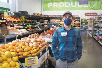  ??  ?? Community Foods Market CEO Brahm Ahmadi has started an 11thhour campaign to save West Oakland’s only fullscale grocery store, which opened in 2019 before the pandemic.