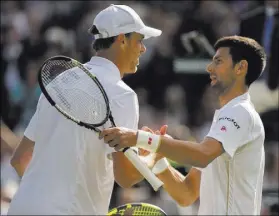  ?? SUSAN MULLANE/USA TODAY ?? Sam Querrey, left, and top-ranked Novak Djokovic of Serbia meet at the net after the 41st-ranked U.S. player’s four-set victory in the third round of Wimbledon in London on Saturday.