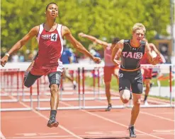  ??  ?? Taos’ Dalton Donaldson, right, lunges to finish in second place Saturday in the 110-meter hurdles.