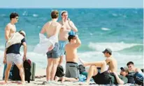  ?? FLORIDA SUN SENTINEL PHOTOS AMY BETH BENNETT/SOUTH ?? Beachgoers enjoy the day in Fort Lauderdale on Friday. Police patrols are ramping up, both uniformed and undercover, to stop underage drinking, thefts, fighting, or worse during Spring Break.