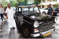  ??  ?? Indian taxi driver Dawood Khan, 80, stands next to his Premiere Padmini taxi after dropping off a customer in Mumbai.