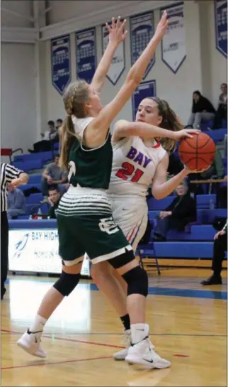  ?? RANDY MEYERS — FOR THE MORNING JOURNAL ?? Bay’s Haley Andrejcak looks to pass around Emily Rapacz of Elyria Catholic on Jan. 5.