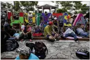  ?? MOISES CASTILLO / ASSOCIATED PRESS ?? Central American migrants making their way to the U.S. rest in a park after arriving in Huixtla, Mexico, on Monday.