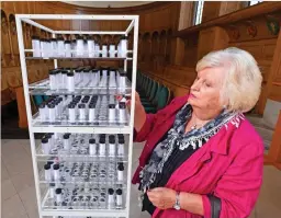  ??  ?? Poignant: Gill Purnell adds a vial, containing a message to her dead husband, to a display commemorat­ing victims