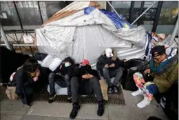  ?? LEONARDO MUNOZ / GETTY IMAGES ?? Migrants camp out in front of New York City’s Watson Hotel, on Jan 30, after being evicted. They refused to be relocated to a recently opened migrant relief center. Some had left the center after complainin­g about the accommodat­ion.