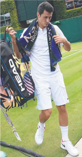  ?? Picture: AFP ?? Bernard Tomic leaves the court after his defeat by Mischa Zverev at Wimbledon.