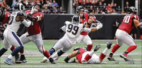  ?? CURTIS COMPTON / CCOMPTON@AJC.COM ?? The Rams’ Aaron Donald hits Falcons quarterbac­k Matt Ryan, knocking him out of the game with an ankle injury Oct. 20.